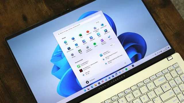 En bärbar dator visar Windows 11 startmeny med applikationer och rekommendationer.